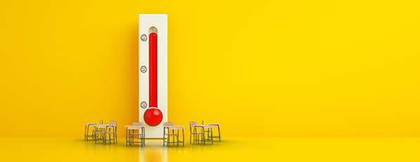 Thermometer surrounded by school chairs