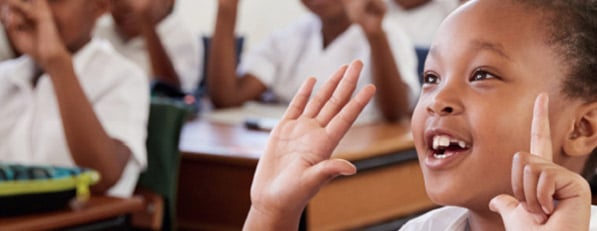 Happy Child in school counting on fingers